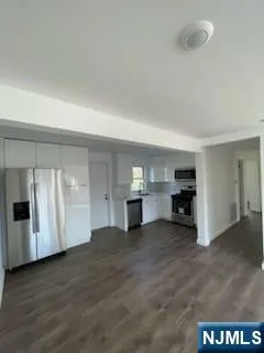 a view of a kitchen with a sink and cabinets