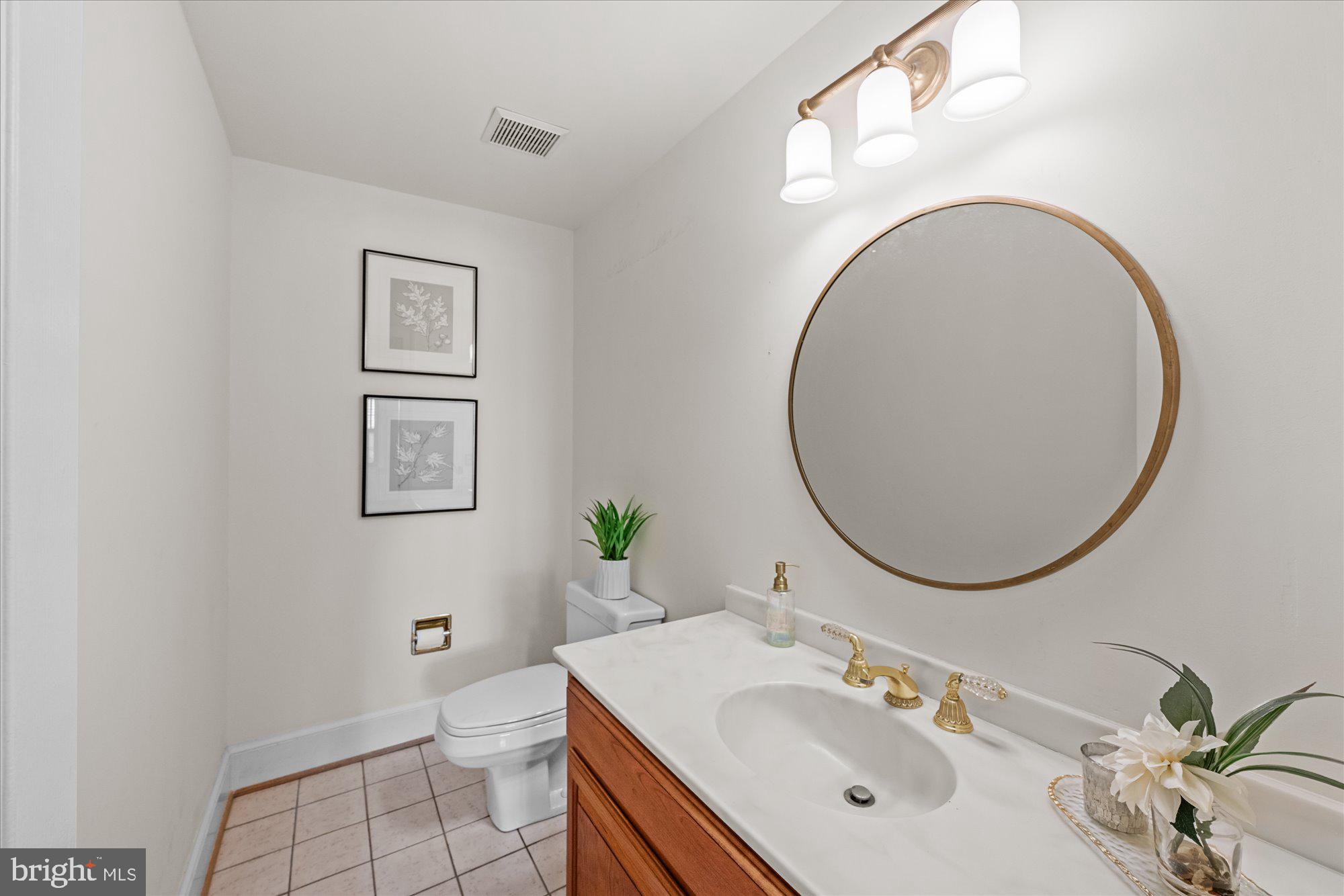 8025 Rising Ridge Road Bethesda, MD 20817 - Photo 15 of 34 a bathroom with a sink mirror and toilet