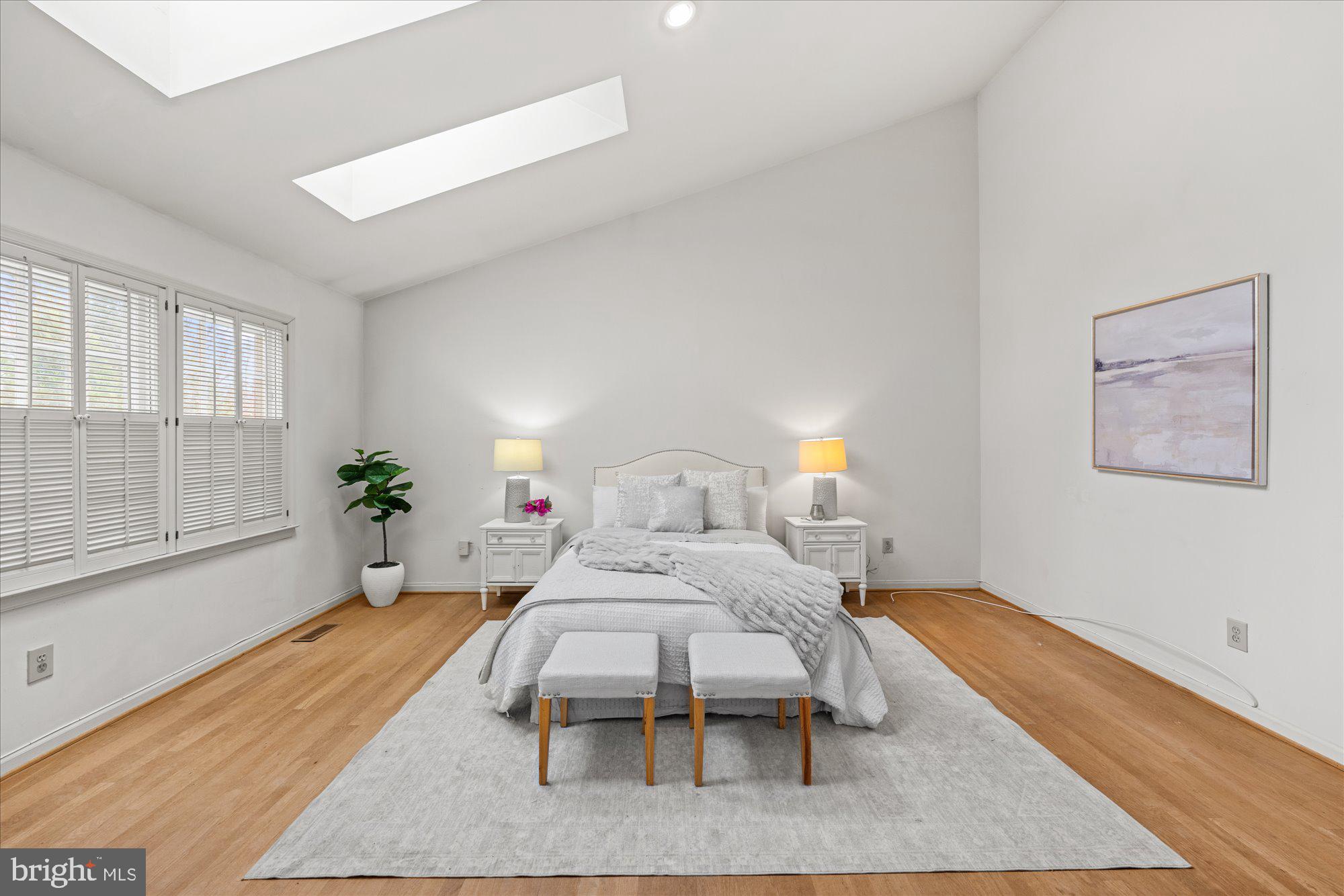 8025 Rising Ridge Road Bethesda, MD 20817 - Photo 16 of 34 a bedroom with a bed and wooden floor