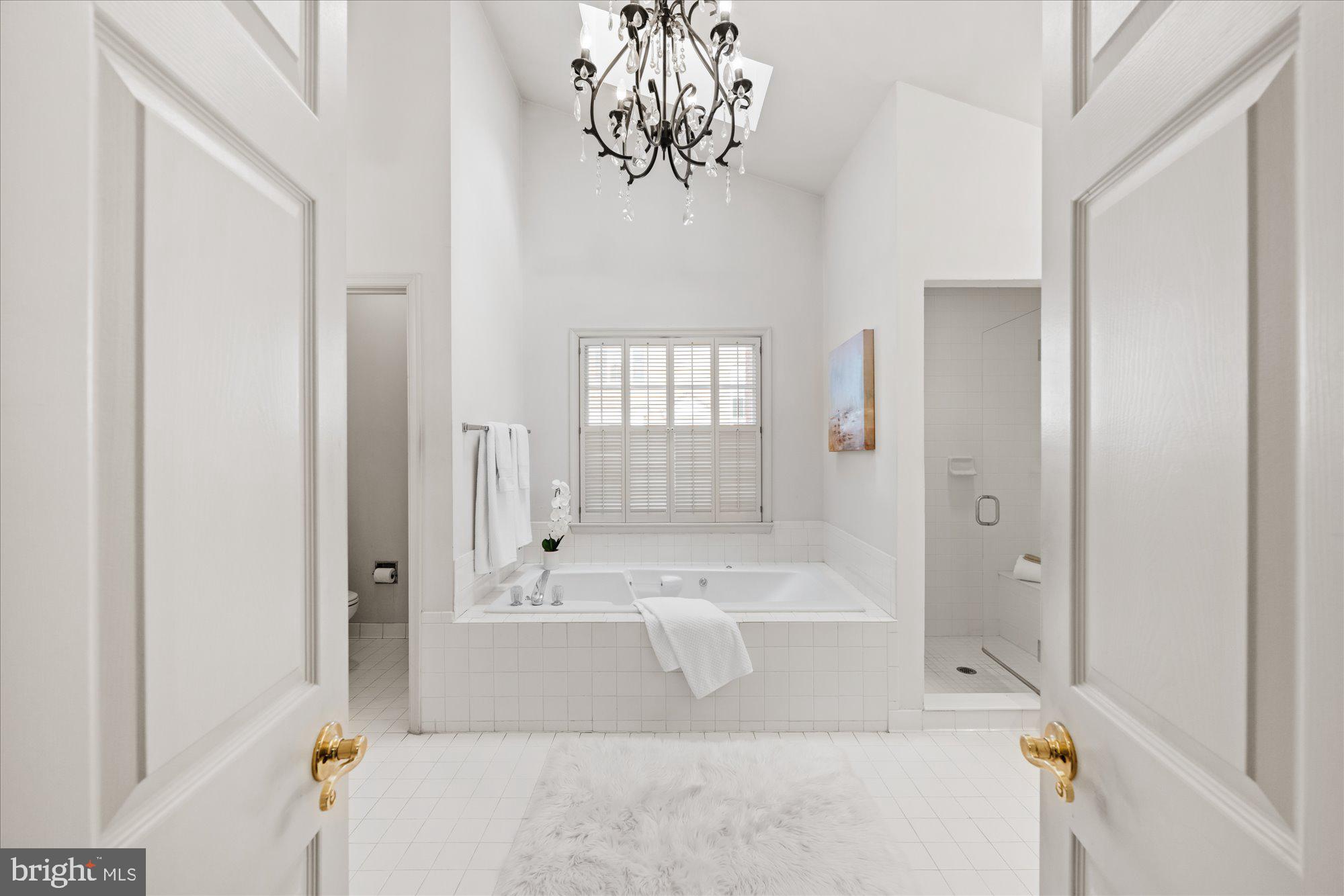8025 Rising Ridge Road Bethesda, MD 20817 - Photo 18 of 34 a bathroom with a bathtub and a shower
