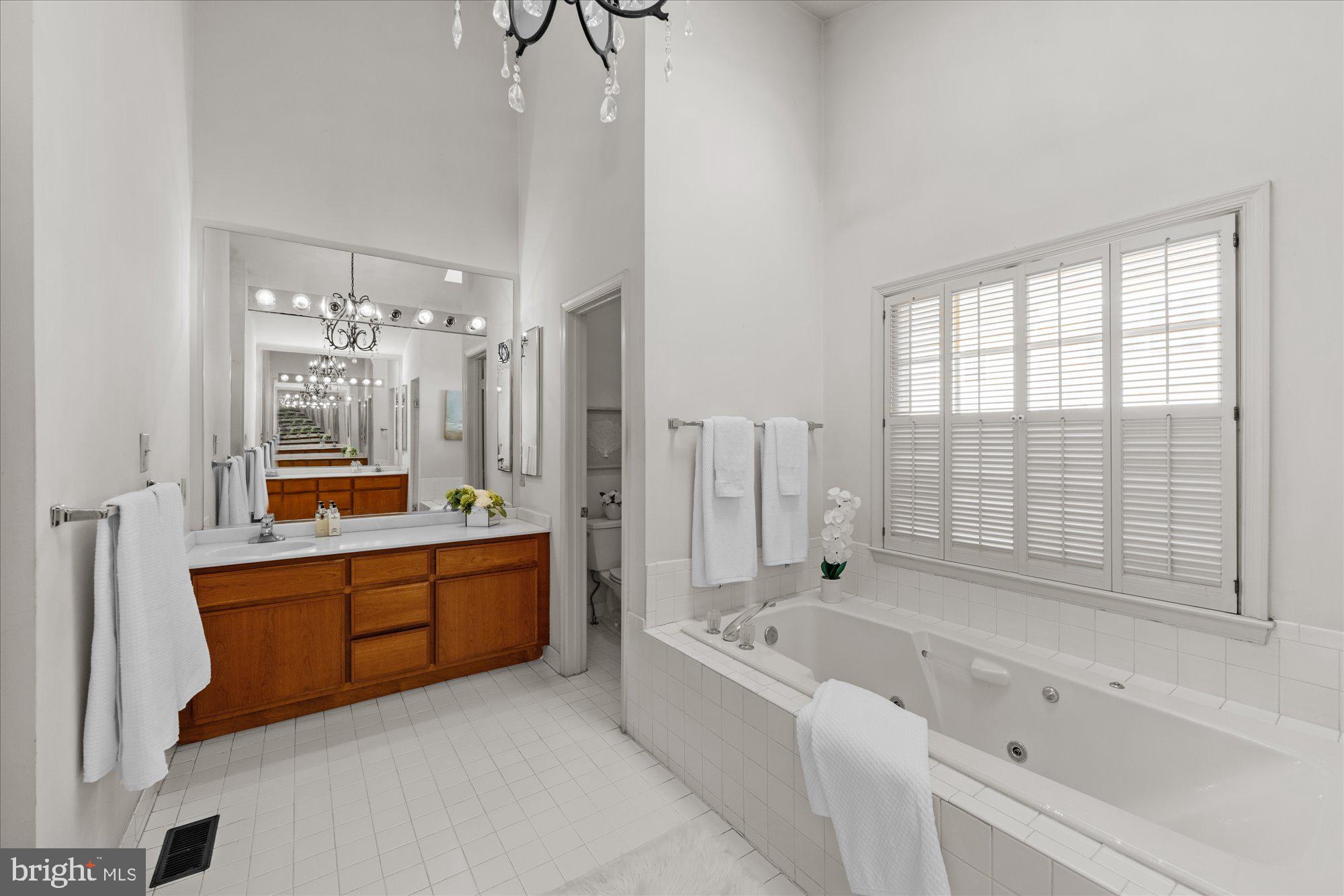 8025 Rising Ridge Road Bethesda, MD 20817 - Photo 19 of 34 a large spacious bathroom with a large tub and shower