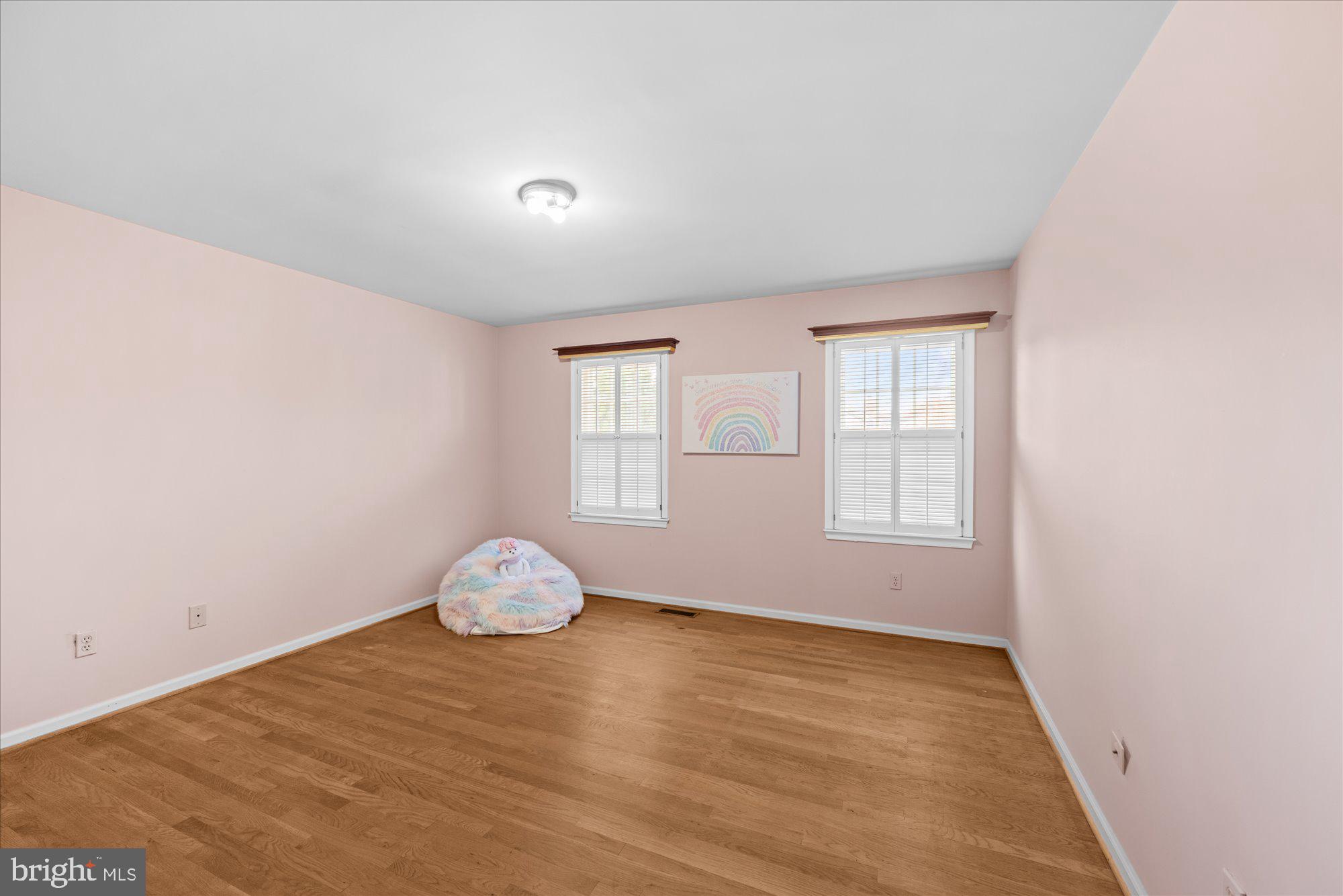 8025 Rising Ridge Road Bethesda, MD 20817 - Photo 20 of 34 an empty room with wooden floor and windows