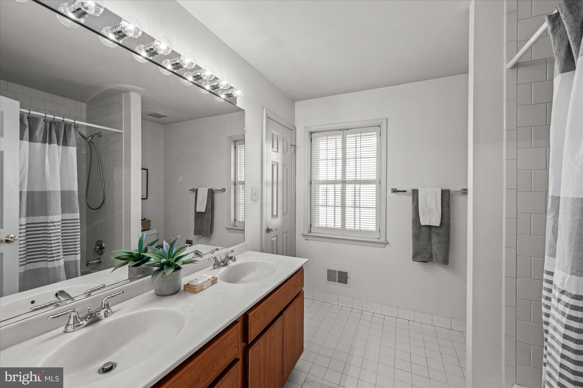 8025 Rising Ridge Road Bethesda, MD 20817 - Photo 21 of 34 a bathroom with a sink and a mirror