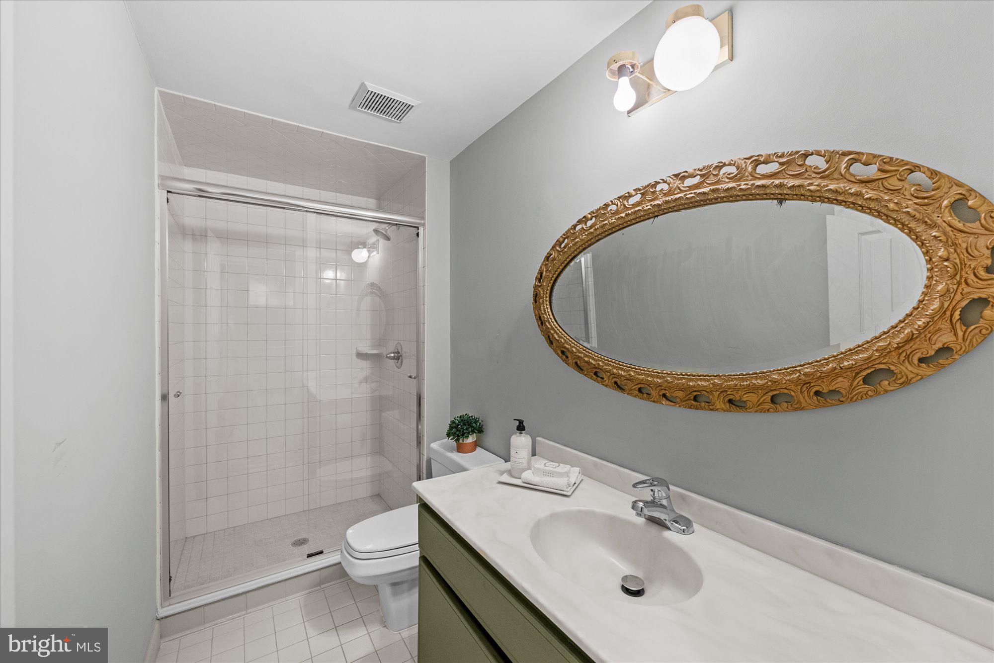8025 Rising Ridge Road Bethesda, MD 20817 - Photo 29 of 34 a bathroom with a sink mirror vanity and toilet