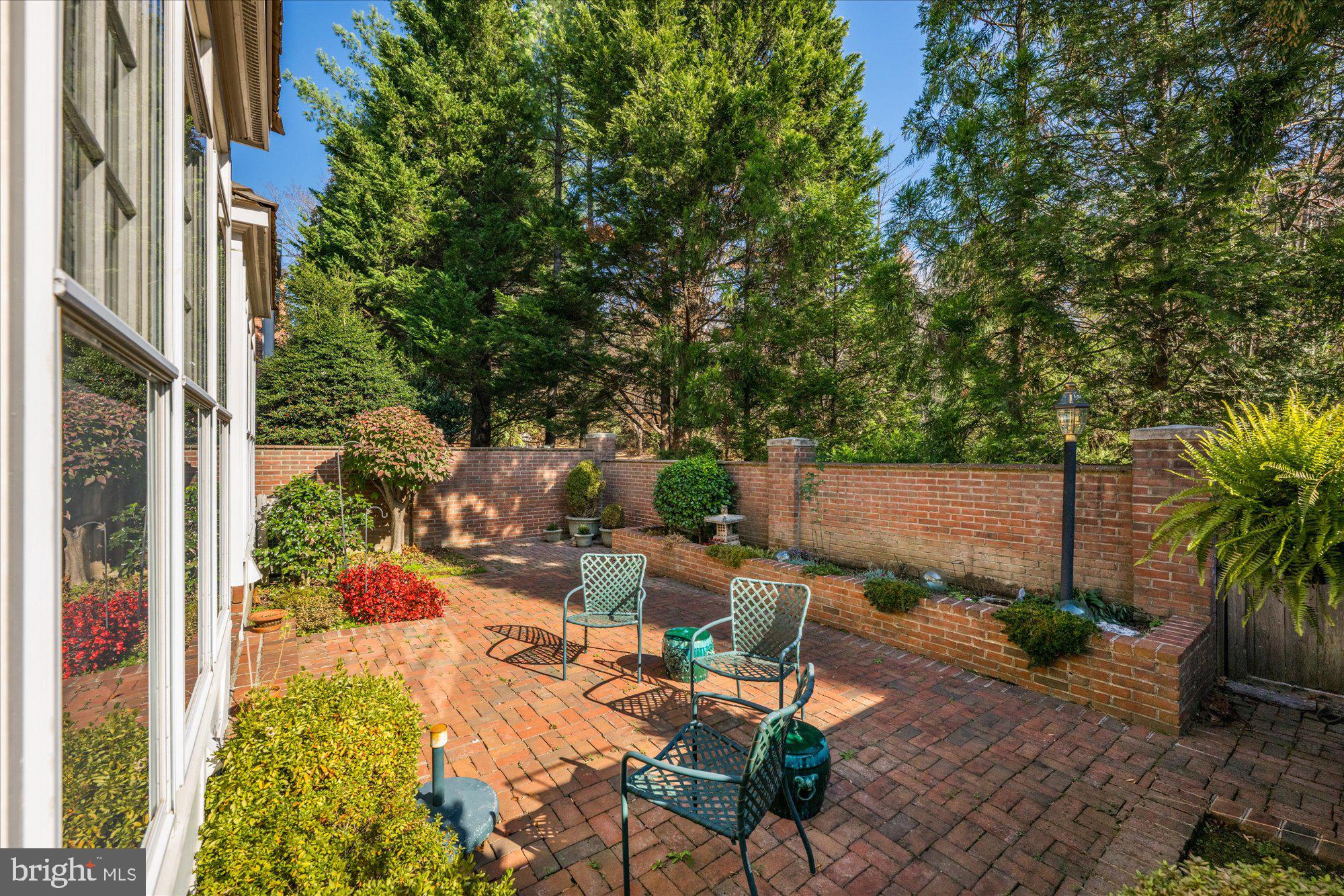 8025 Rising Ridge Road Bethesda, MD 20817 - Photo 30 of 34 a view of a patio with table and chairs potted plants and large tree