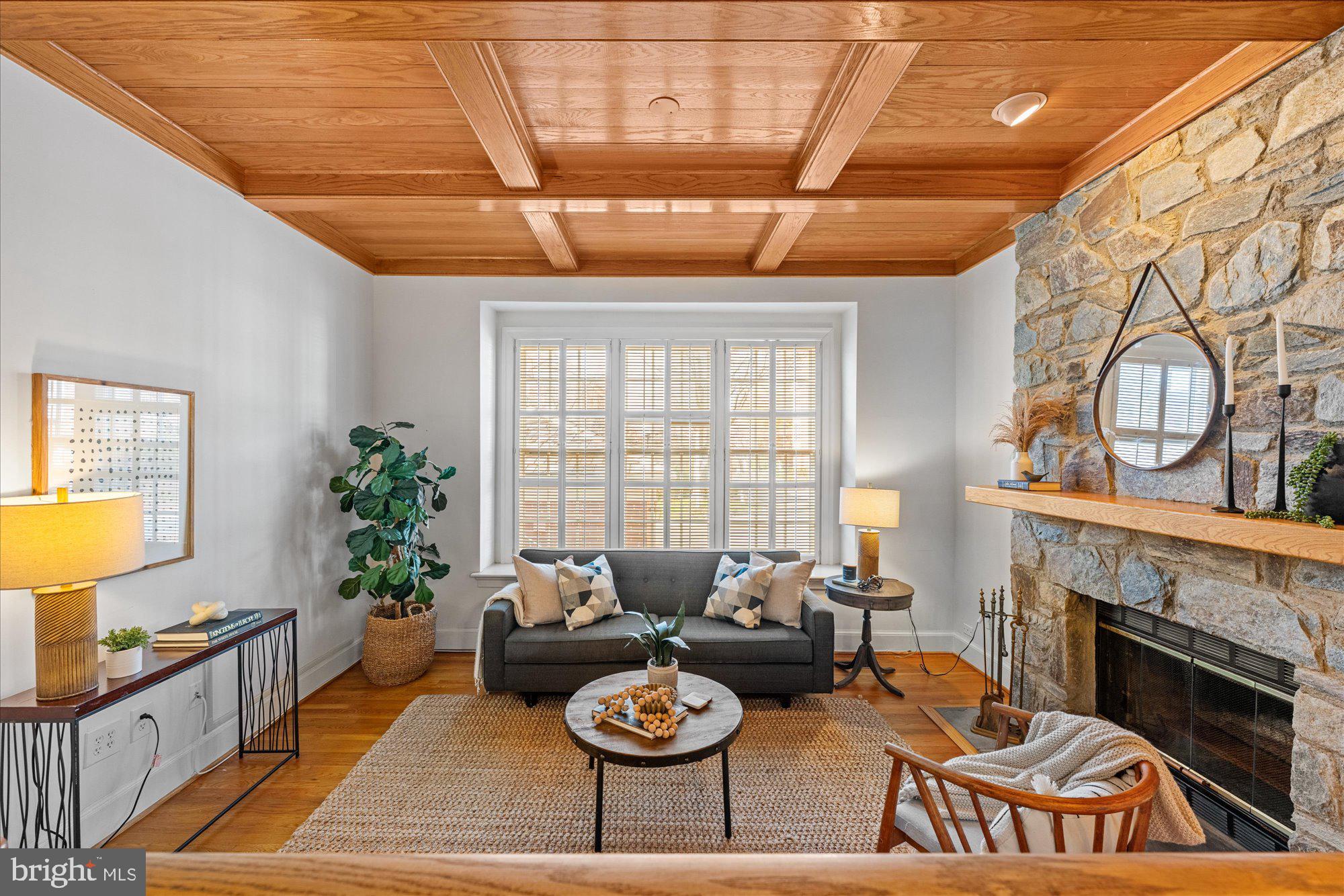 8025 Rising Ridge Road Bethesda, MD 20817 - Photo 6 of 34 a living room with furniture a fireplace and a table