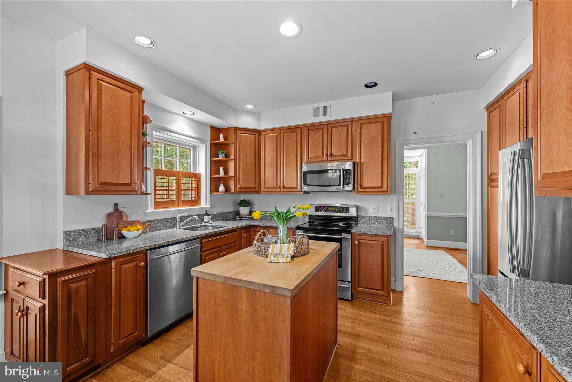 8025 Rising Ridge Road Bethesda, MD 20817 - Photo 9 of 34 a kitchen with stainless steel appliances a sink dishwasher stove refrigerator and cabinets