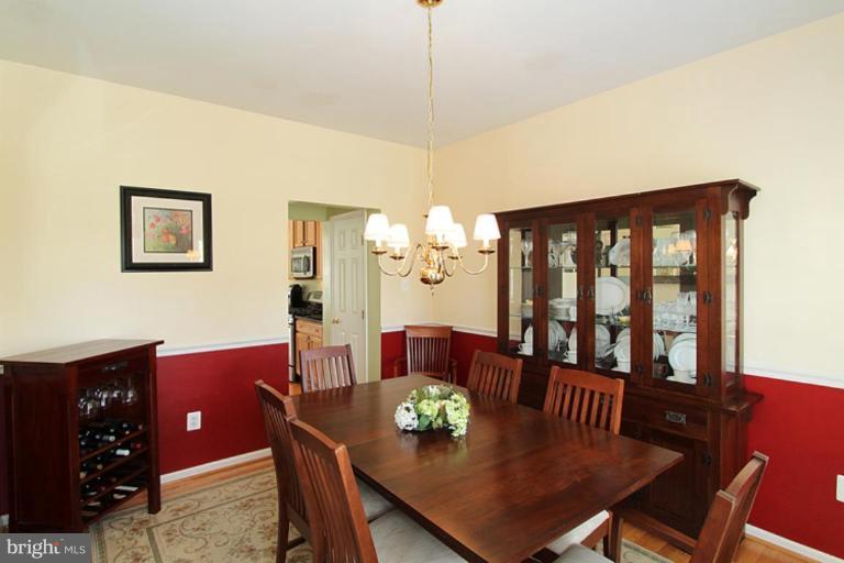 18409 Cornflower Road Boyds, MD 20841 - Photo 19 of 24 a view of a dining room with furniture and chandelier