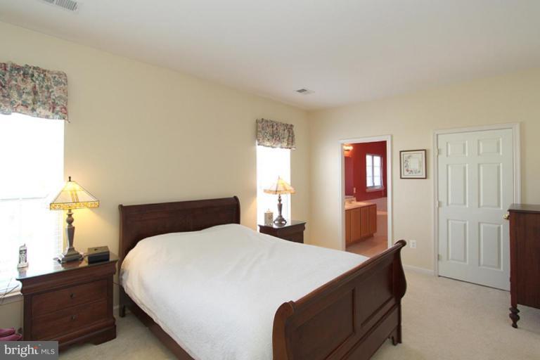 18409 Cornflower Road Boyds, MD 20841 - Photo 21 of 24 a bedroom with a bed and lamps