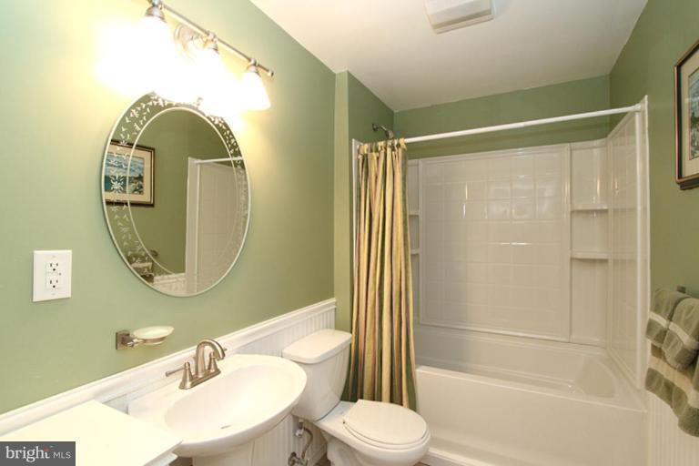 18409 Cornflower Road Boyds, MD 20841 - Photo 24 of 24 a bathroom with a sink mirror toilet and shower