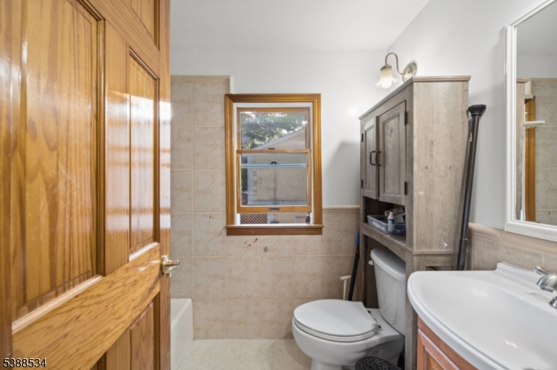 136 Haroldson Place Pompton Lakes, NJ 07442 - Photo 15 of 23 a bathroom with a sink a toilet a mirror and shower