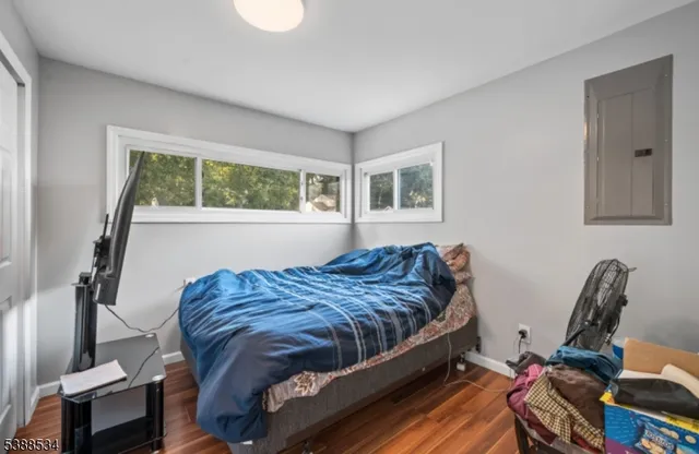 a living room with a bed furniture and a window