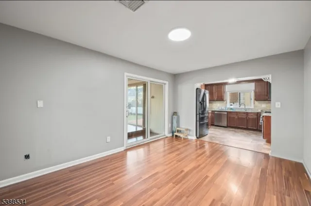 a view of a kitchen with wooden floor and a kitchen
