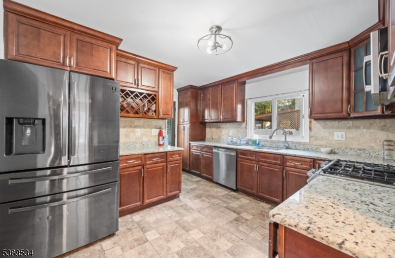136 Haroldson Place Pompton Lakes, NJ 07442 - Photo 8 of 23 a kitchen with stainless steel appliances granite countertop a refrigerator sink and stove