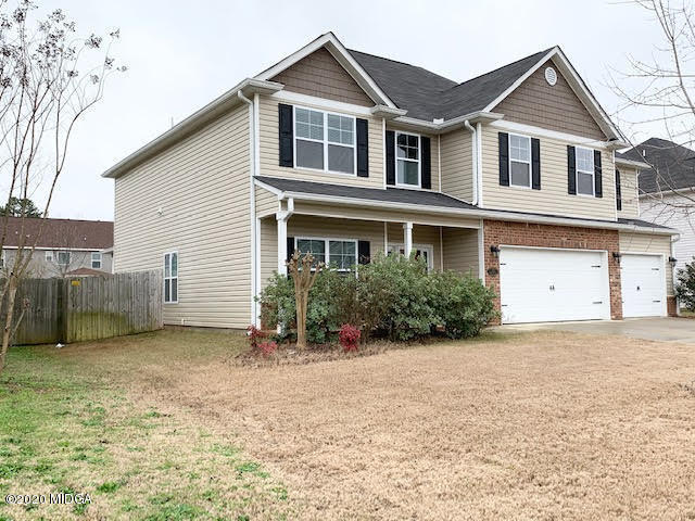 203 Longbridge Way Perry, GA 31069 - Photo 2 of 31 a view of a house with a yard and large tree
