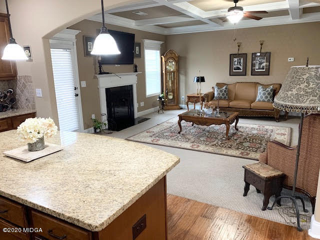 203 Longbridge Way Perry, GA 31069 - Photo 16 of 31 a living room with granite countertop kitchen island furniture and a fireplace