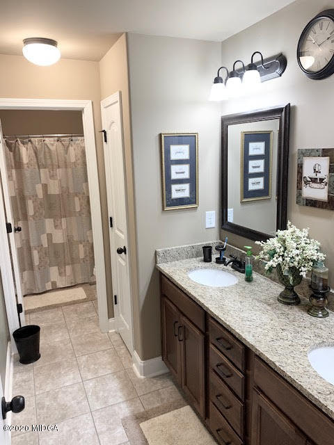 203 Longbridge Way Perry, GA 31069 - Photo 25 of 31 a bathroom with a sink a toilet and mirror