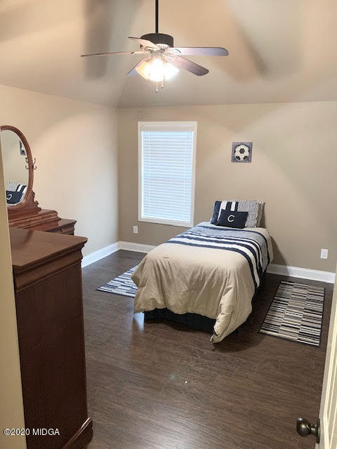 203 Longbridge Way Perry, GA 31069 - Photo 27 of 31 a bedroom with a bed and a chandelier