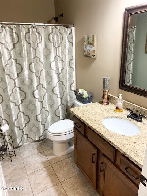 203 Longbridge Way Perry, GA 31069 - Photo 28 of 31 a bathroom with a granite countertop sink a toilet and a mirror