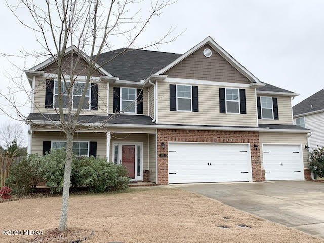 203 Longbridge Way Perry, GA 31069 - Photo 4 of 31 a front view of a house with a yard and garage