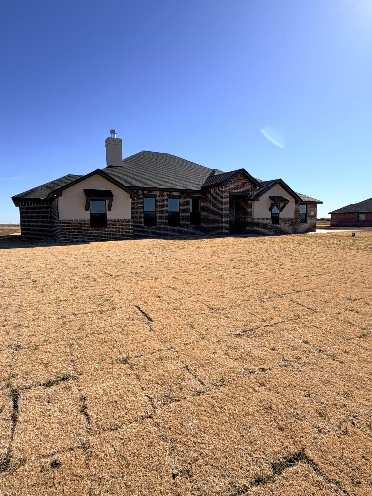a front view of a house with yard