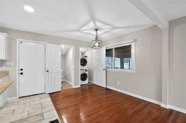 a big room with wooden floor and windows