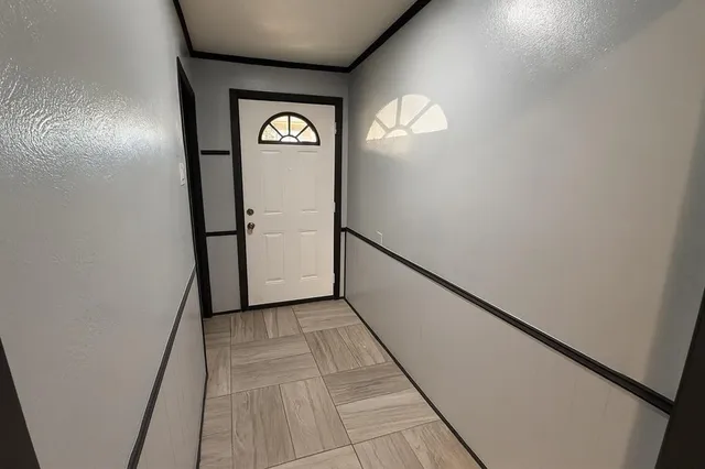 a view of a hallway with wooden floor