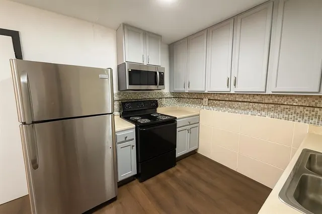 a kitchen with a refrigerator stove and microwave