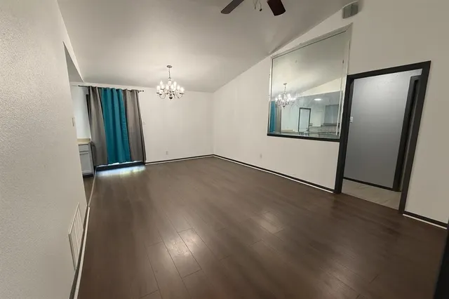 wooden floor in an empty room with a mirror