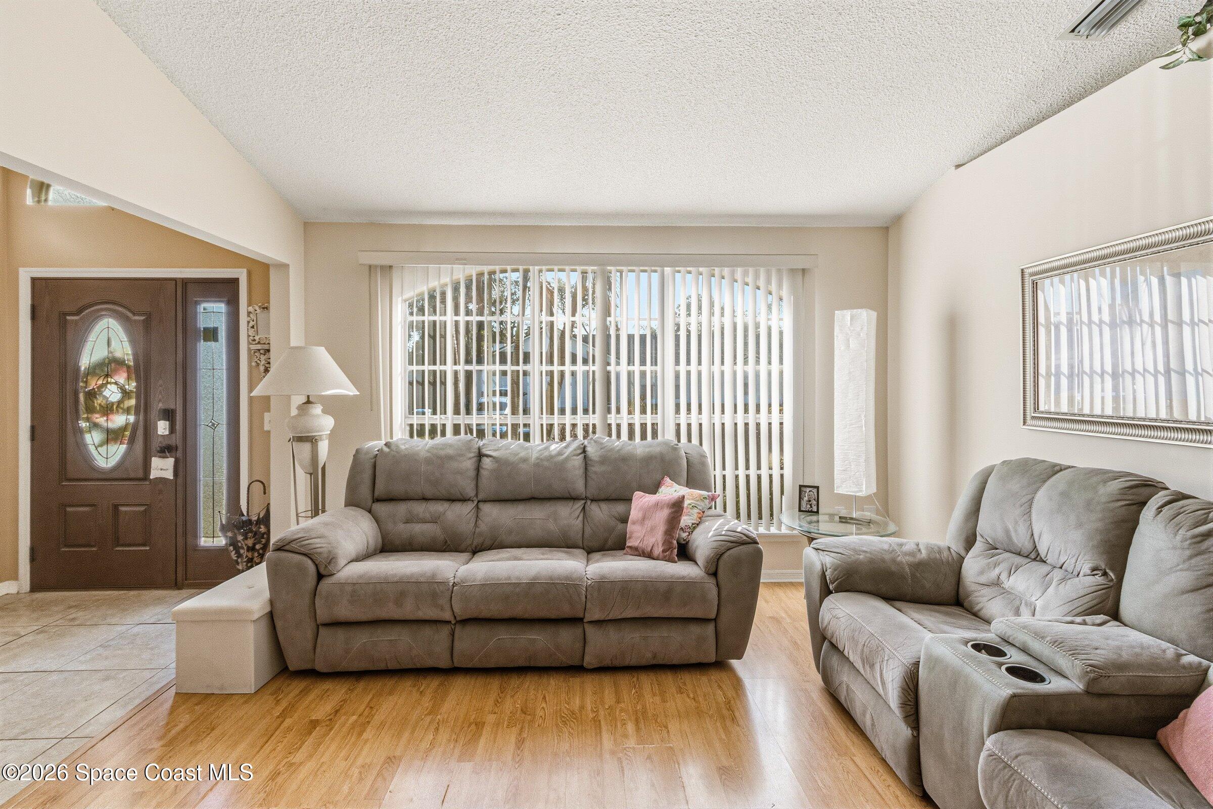 4770 Hidden Creek Road Palm Shores, FL 32935 - Photo 16 of 51 a living room with furniture and a large window