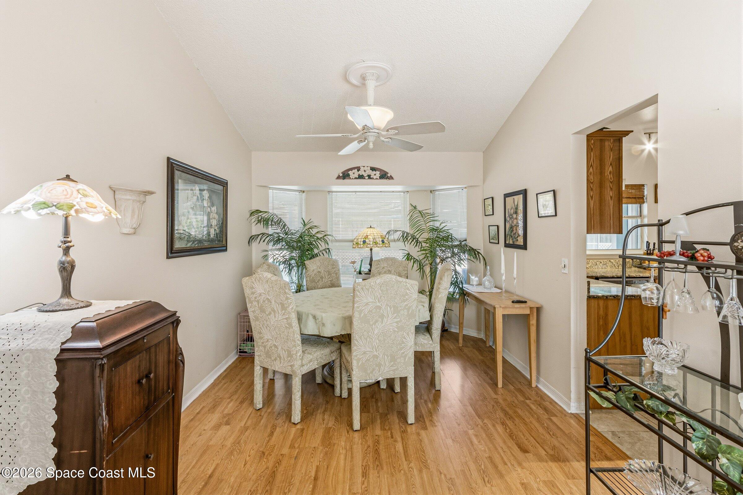 4770 Hidden Creek Road Palm Shores, FL 32935 - Photo 18 of 51 a view of a dining room with furniture and wooden floor