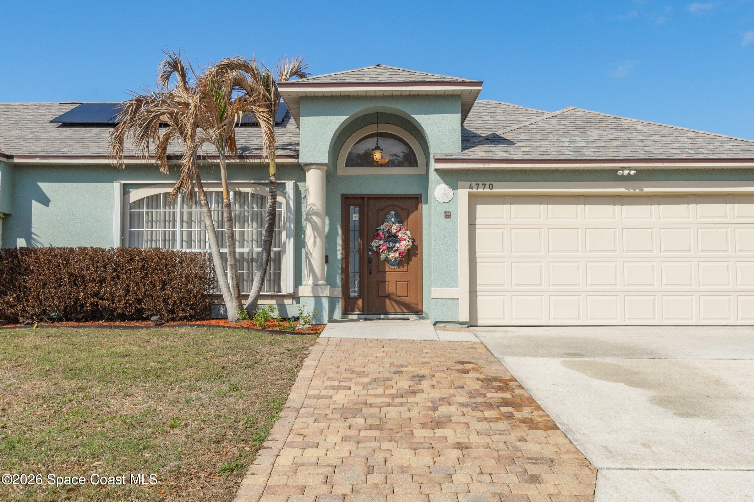 4770 Hidden Creek Road Palm Shores, FL 32935 - Photo 2 of 51 a front view of a house with garden