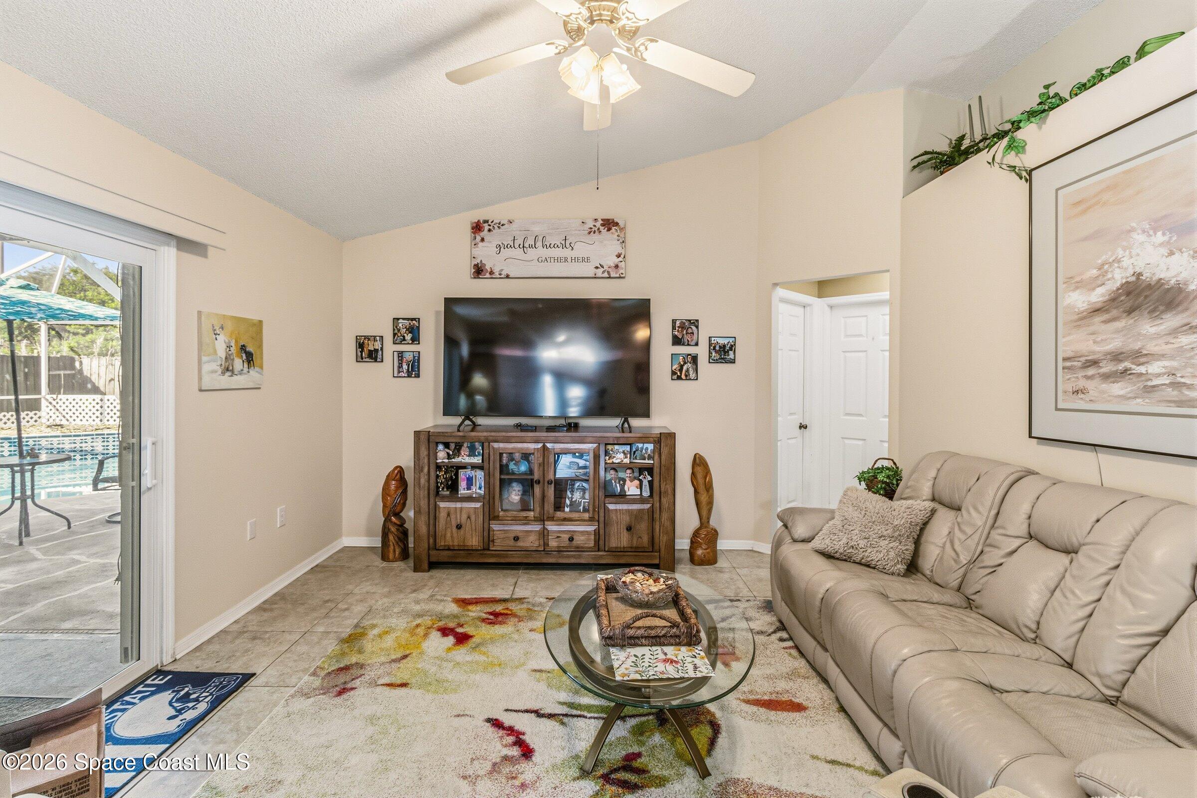 4770 Hidden Creek Road Palm Shores, FL 32935 - Photo 25 of 51 a living room with furniture and a flat screen tv
