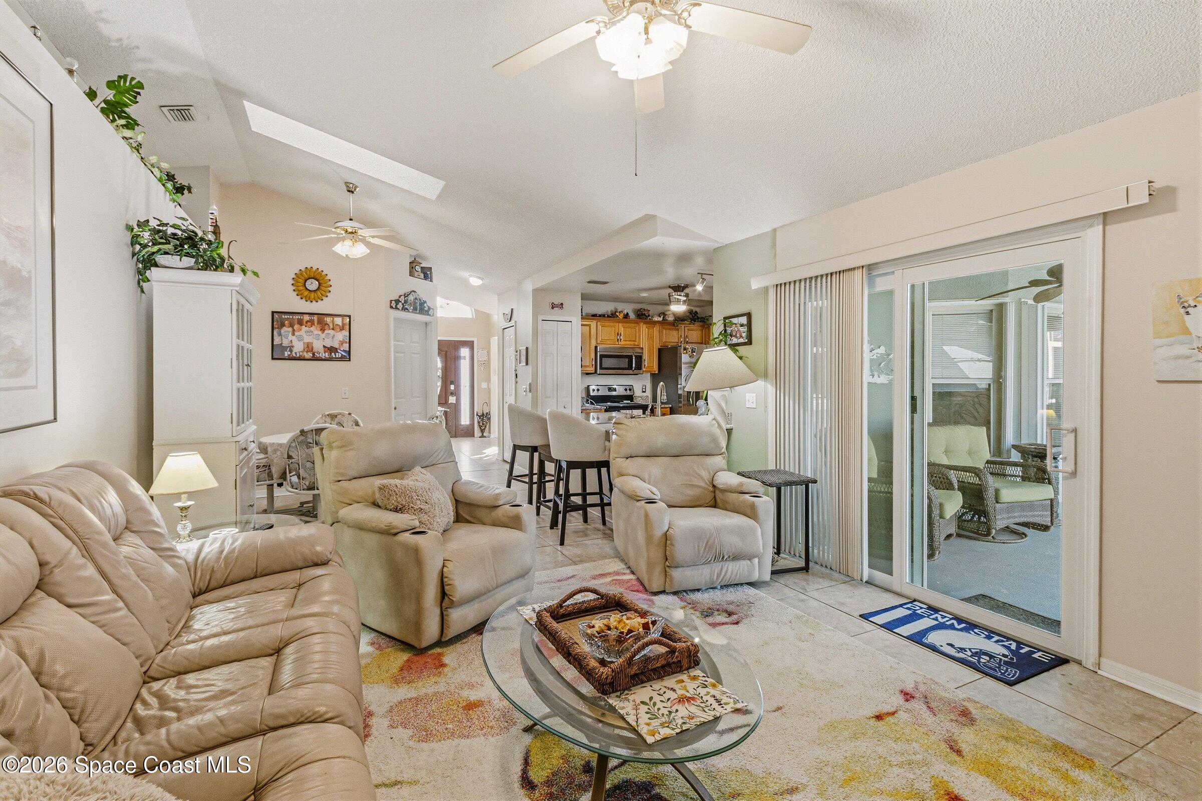 4770 Hidden Creek Road Palm Shores, FL 32935 - Photo 26 of 51 a living room with furniture and a chandelier