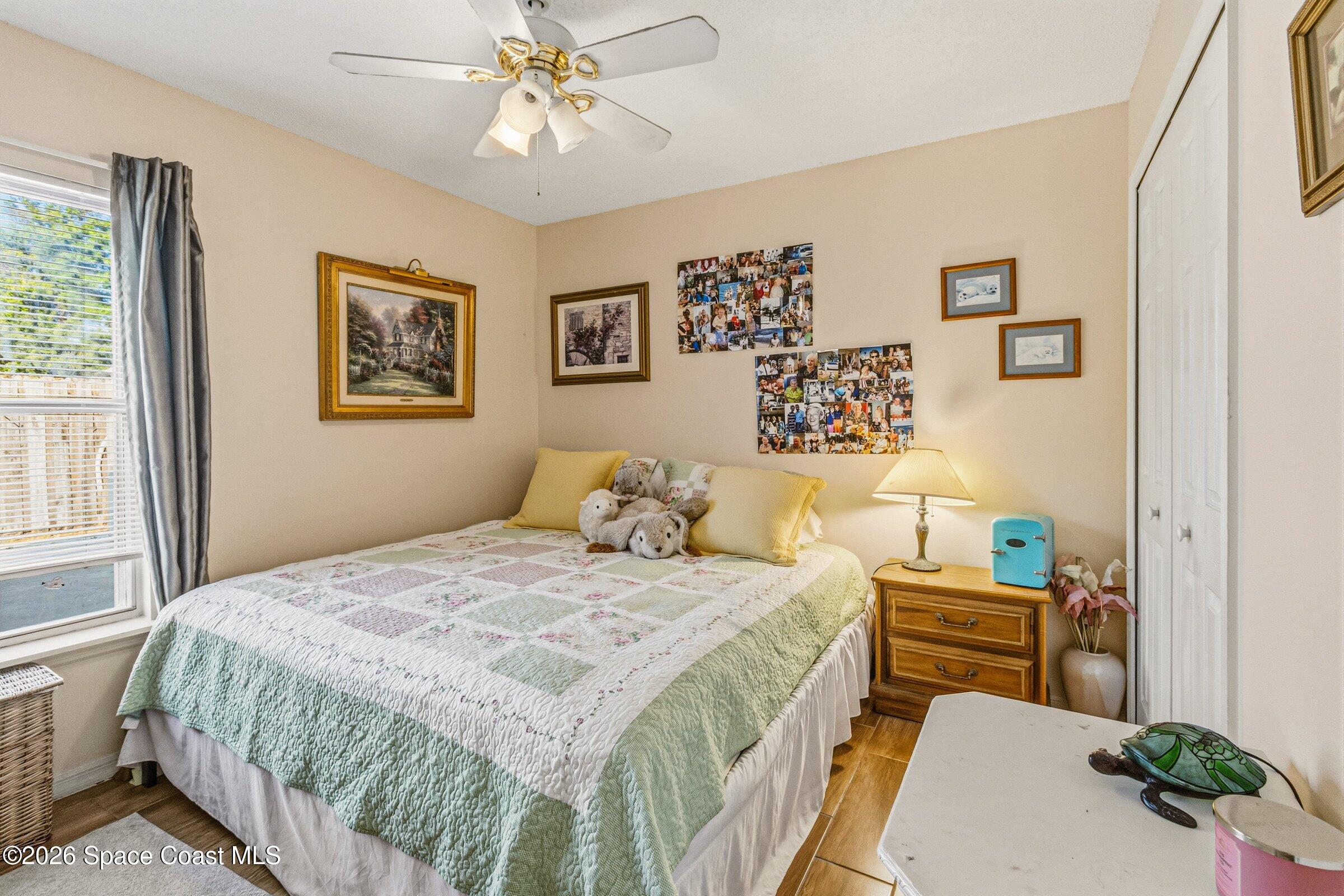 4770 Hidden Creek Road Palm Shores, FL 32935 - Photo 27 of 51 a bedroom with a bed and a chandelier