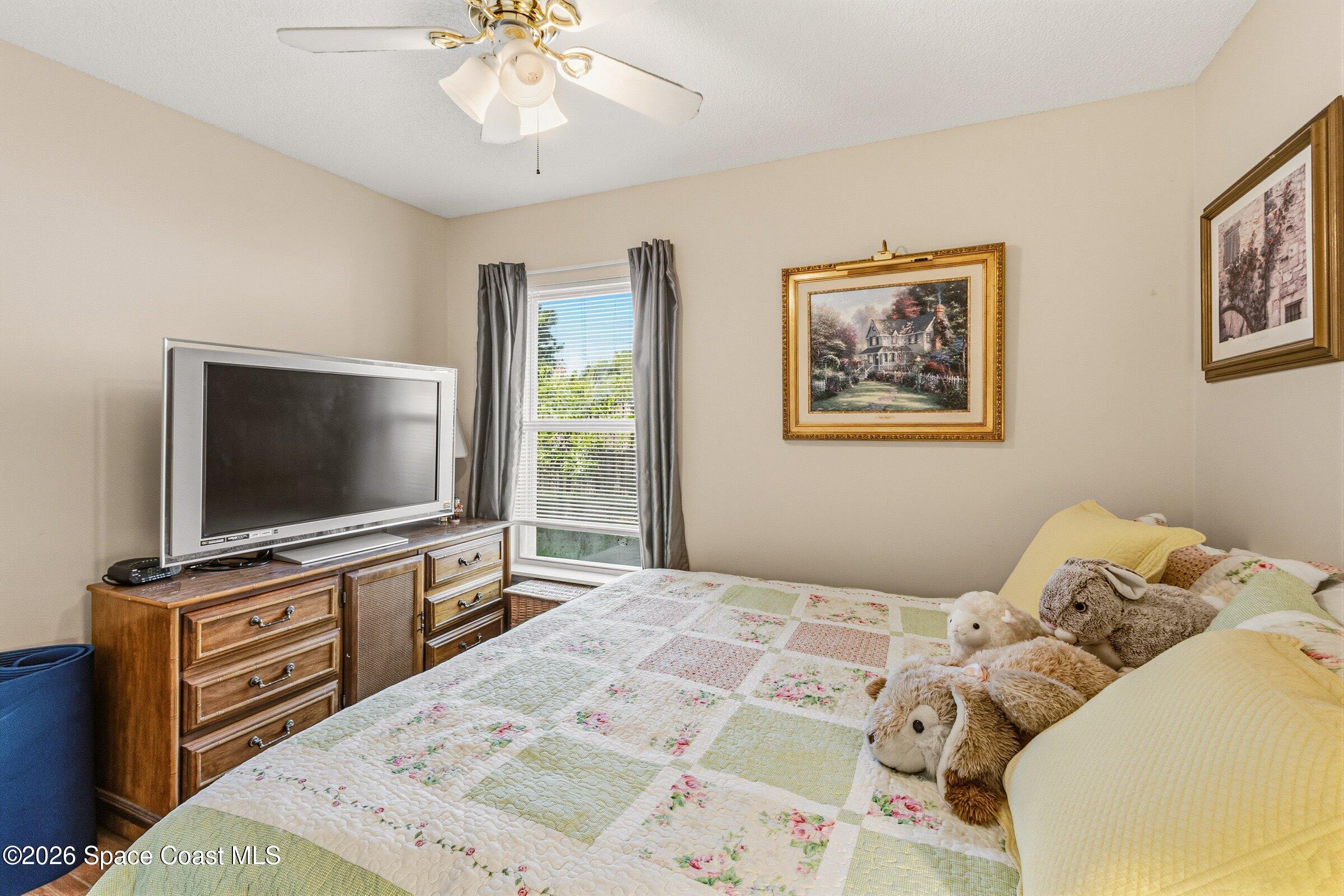 4770 Hidden Creek Road Palm Shores, FL 32935 - Photo 28 of 51 a bedroom with a bed and a flat screen tv