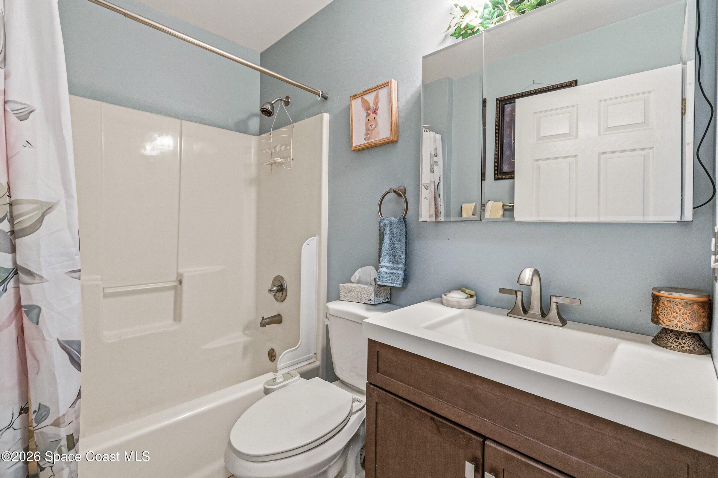 4770 Hidden Creek Road Palm Shores, FL 32935 - Photo 31 of 51 a bathroom with a sink a toilet and shower