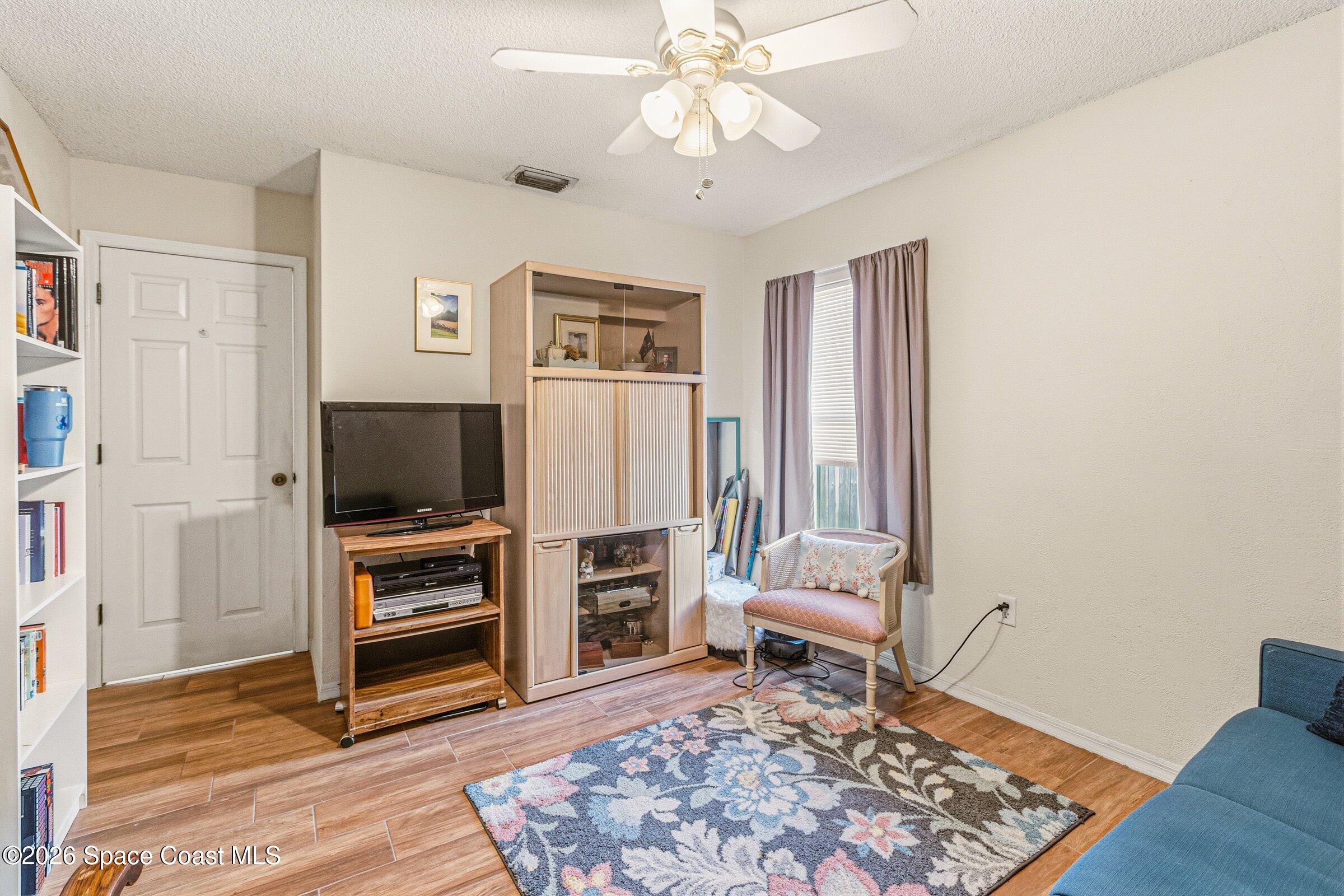 4770 Hidden Creek Road Palm Shores, FL 32935 - Photo 33 of 51 a living room with furniture and a flat screen tv