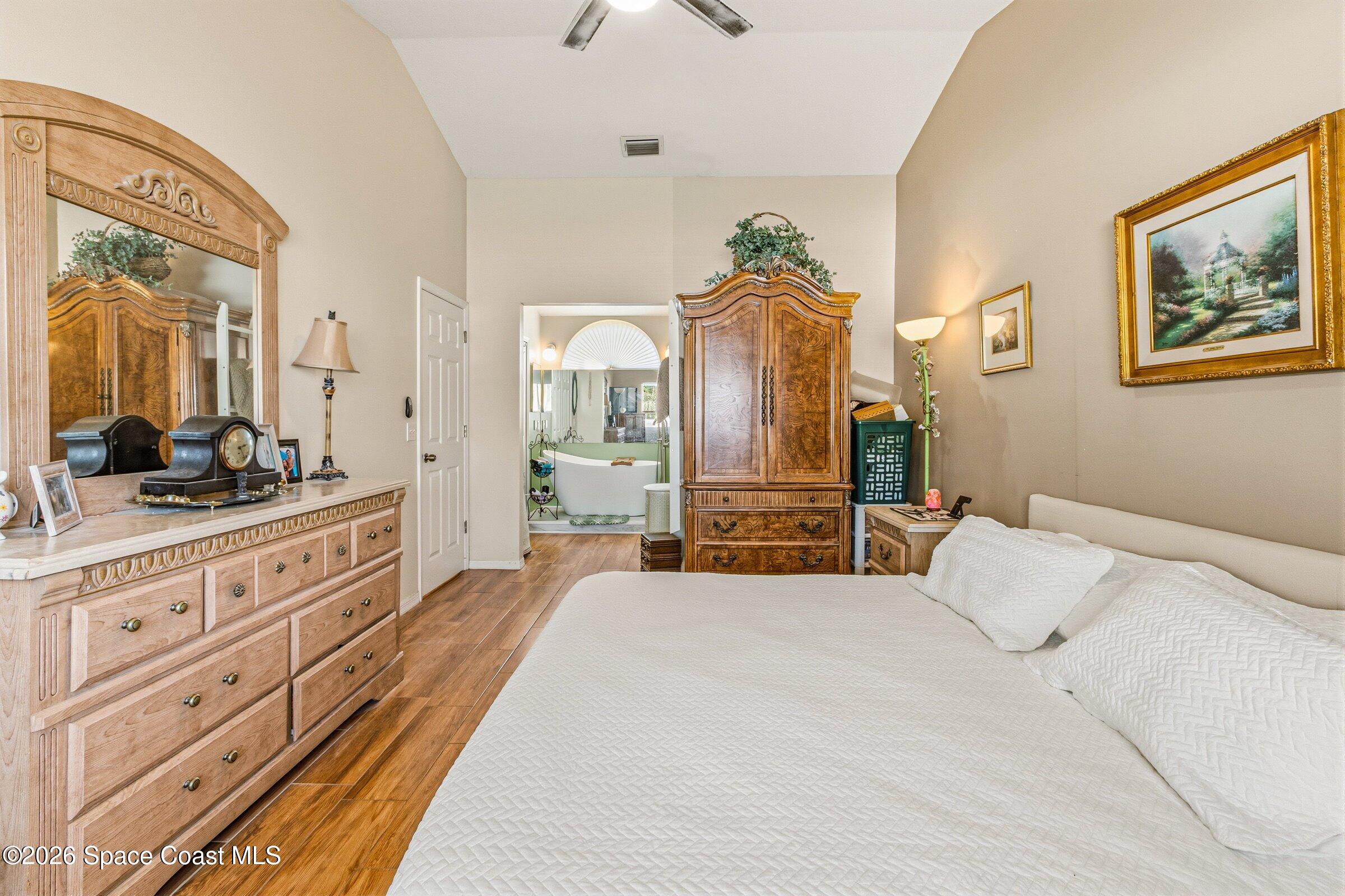 4770 Hidden Creek Road Palm Shores, FL 32935 - Photo 35 of 51 a spacious bedroom with a bed and ceiling fan