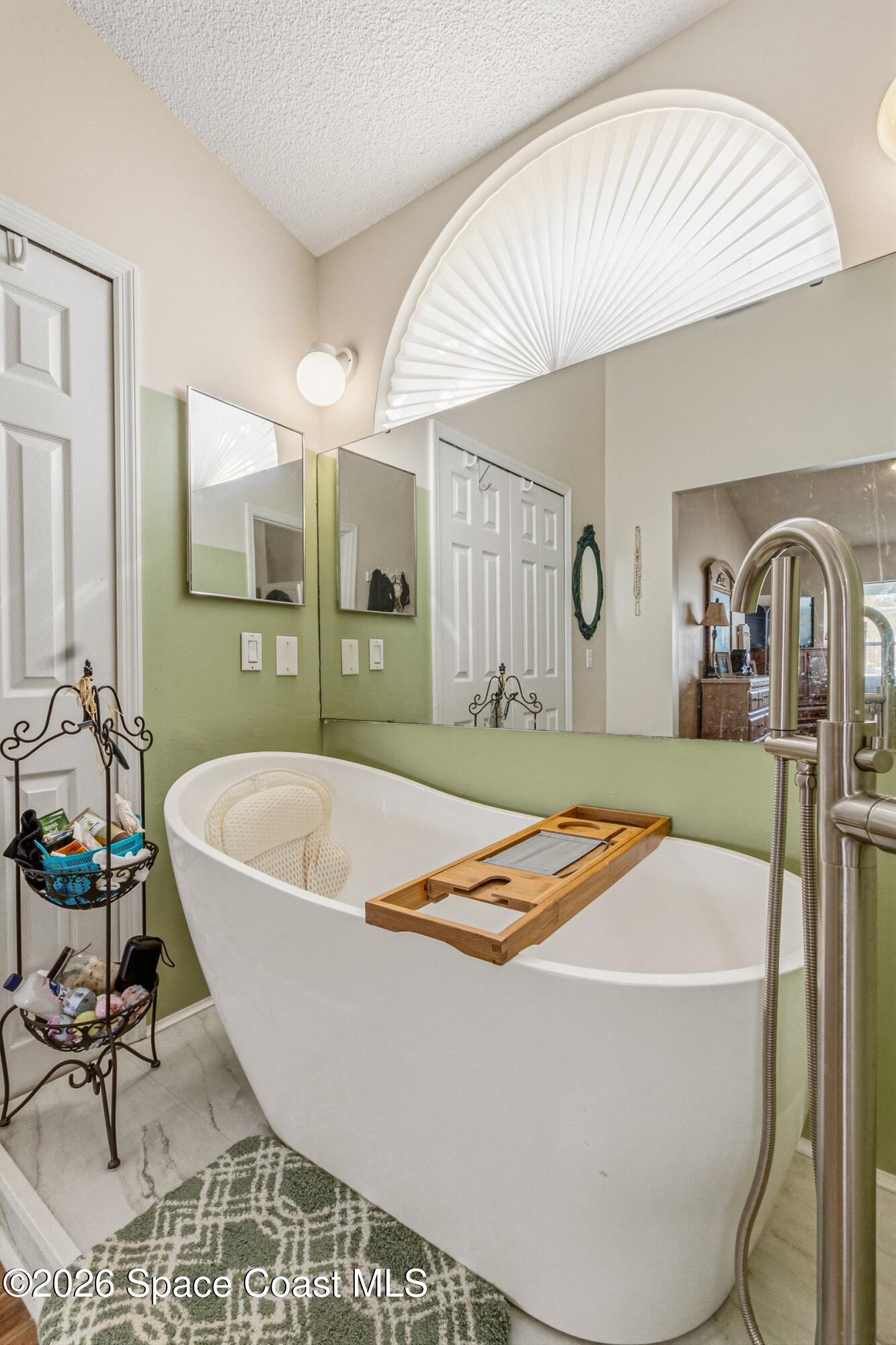 4770 Hidden Creek Road Palm Shores, FL 32935 - Photo 36 of 51 a white bath tub sitting in a bathroom