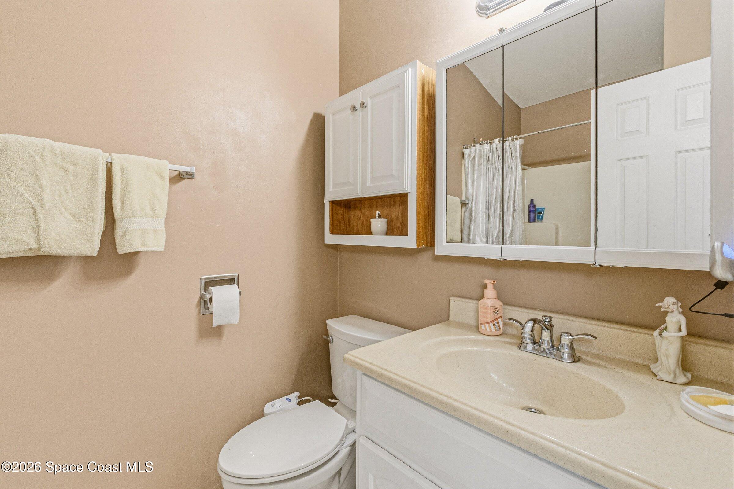 4770 Hidden Creek Road Palm Shores, FL 32935 - Photo 37 of 51 a bathroom with a sink a toilet and shower