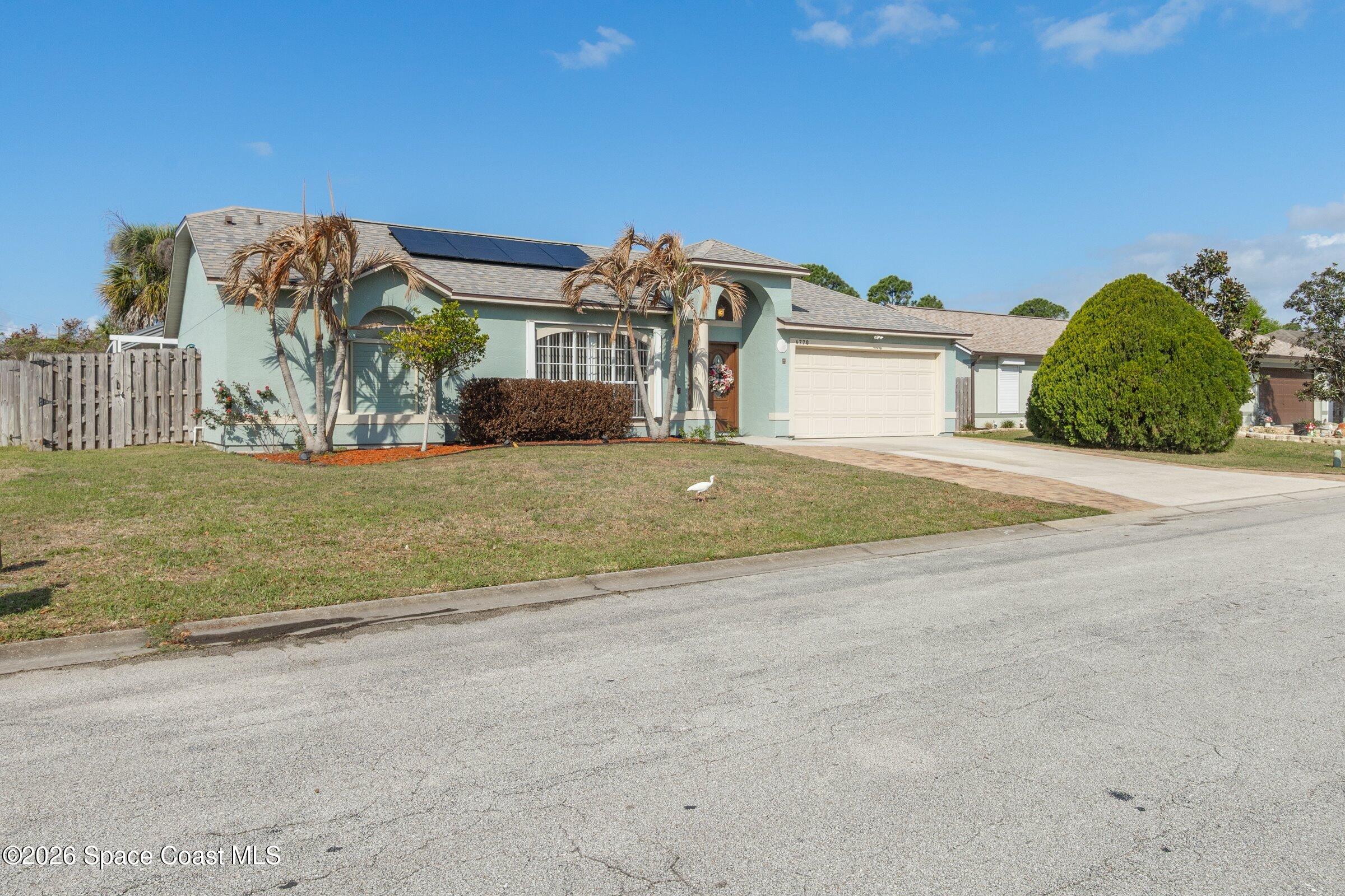 4770 Hidden Creek Road Palm Shores, FL 32935 - Photo 4 of 51 a front view of a house with a yard and garage