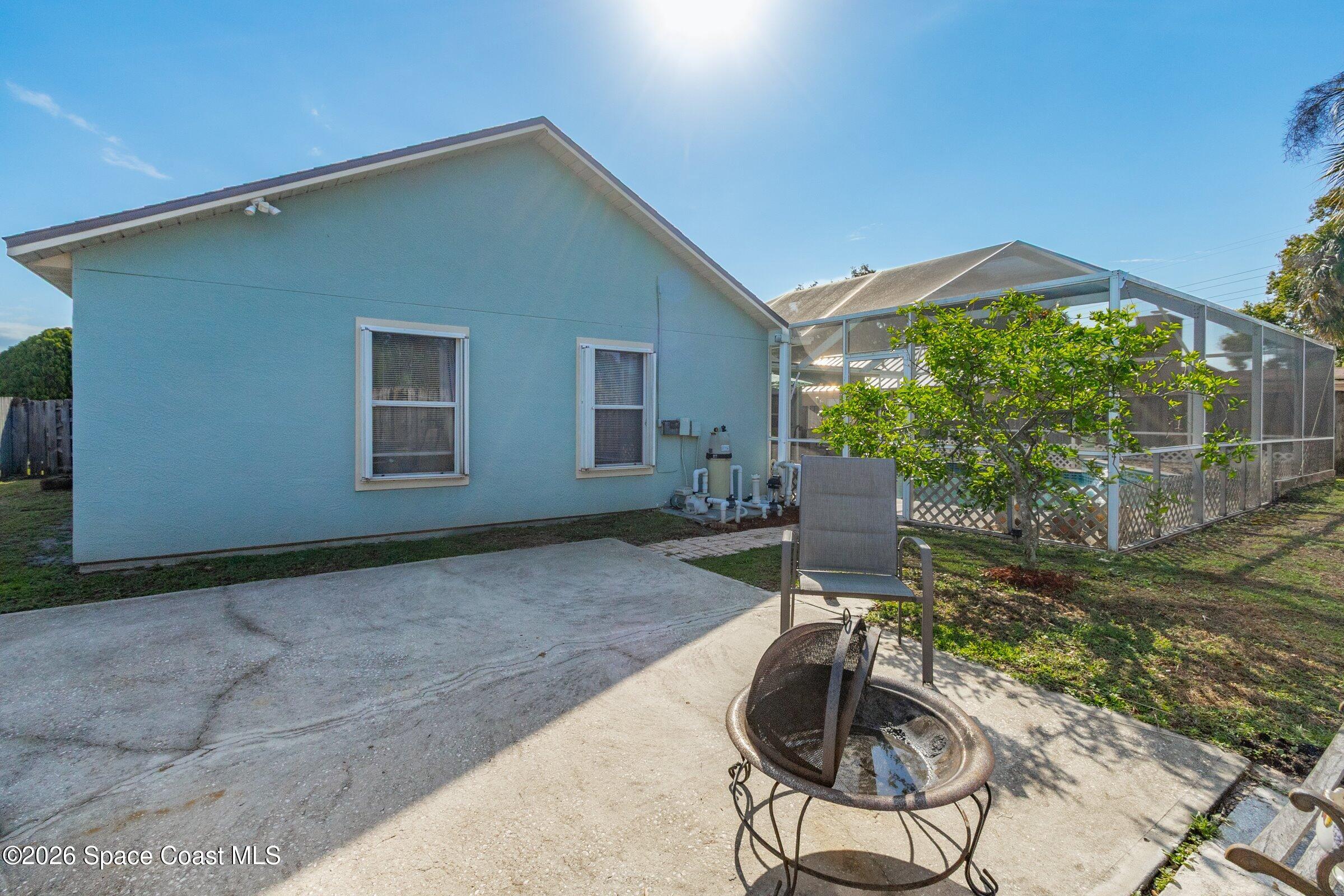 4770 Hidden Creek Road Palm Shores, FL 32935 - Photo 6 of 51 a backyard of a house with table and chairs