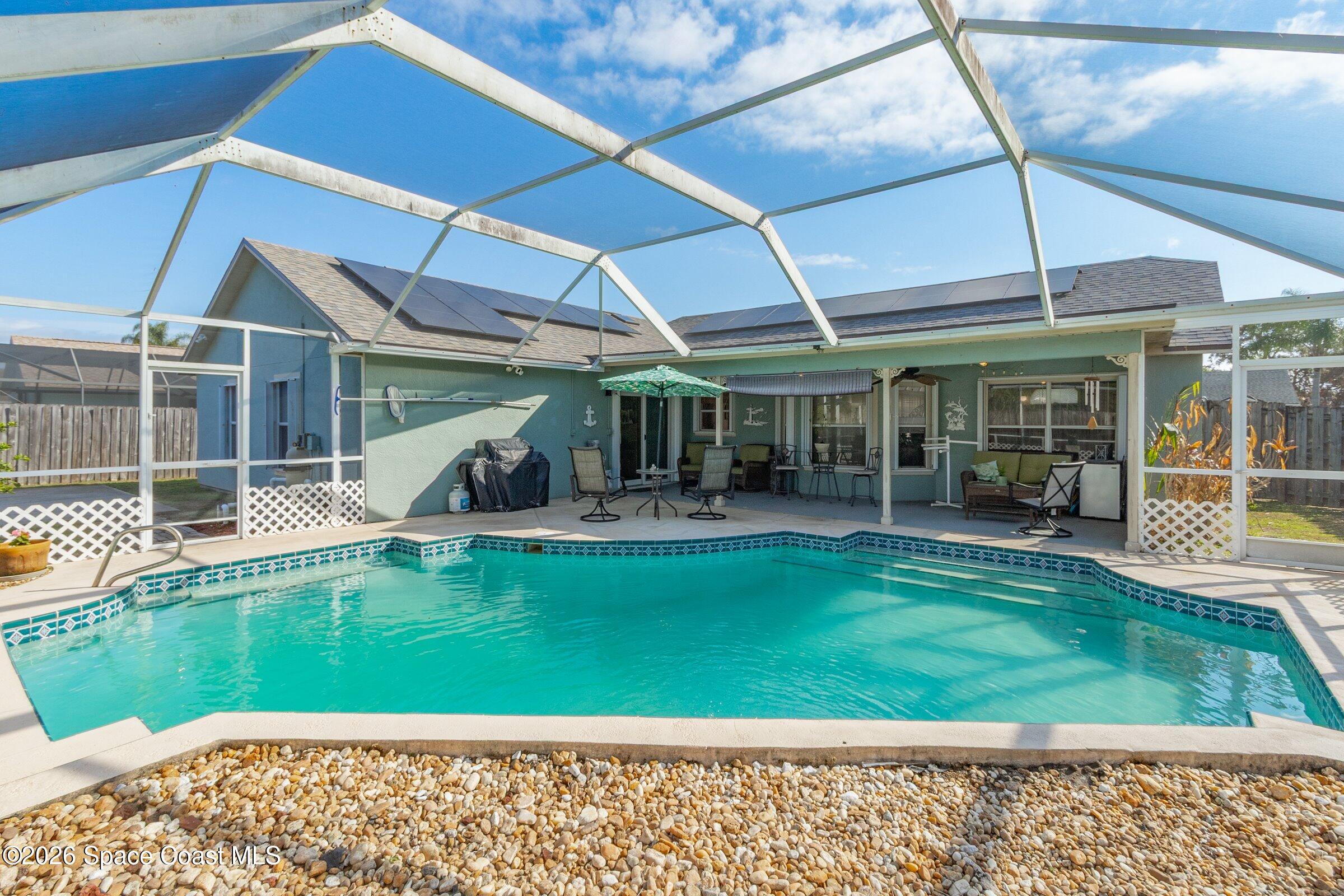 4770 Hidden Creek Road Palm Shores, FL 32935 - Photo 9 of 51 a view of a swimming pool with a patio