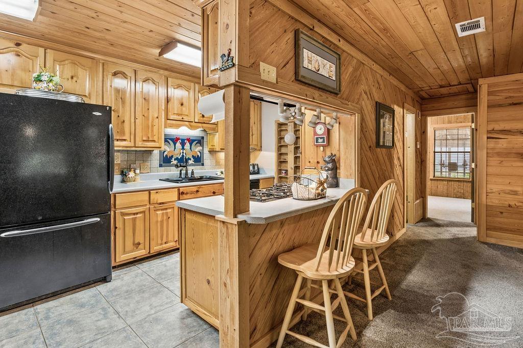 8938 Pioneer Road Holt, FL 32564 - Photo 8 of 44 a kitchen with stainless steel appliances granite countertop a stove and a refrigerator