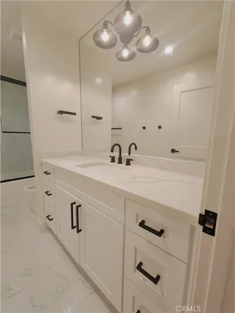 a bathroom with a sink double vanity and a mirror