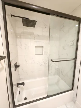 a bathroom with a glass shower door