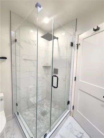 a bathroom with a glass shower door