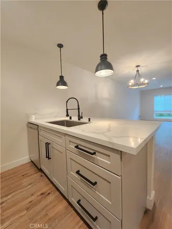 a kitchen with a sink and chandelier