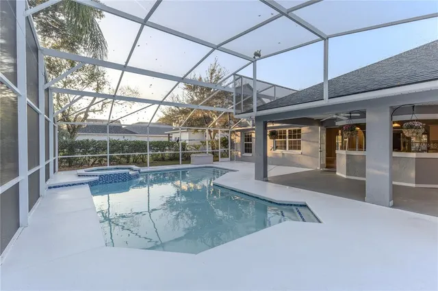 a kitchen with white cabinets and sink